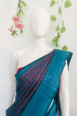 Peacock blue dual tone Banarasi silk saree with a contrasting designer border, comes with a running blouse piece.