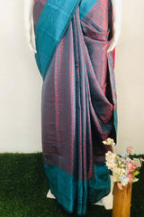 Peacock blue dual tone Banarasi silk saree with a contrasting designer border, comes with a running blouse piece.